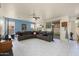 Spacious living room with tile floors, a large sectional sofa, and sliding glass doors to the backyard at 1648 S Faith --, Mesa, AZ 85209
