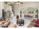Bright and spacious living room featuring high ceilings, modern tile floors, and an open layout that flows into the dining area at 1648 S Faith --, Mesa, AZ 85209