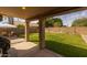 Covered patio area offering shade and a view of the spacious backyard, great for outdoor dining and lounging at 1648 S Faith --, Mesa, AZ 85209
