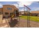 Spacious backyard with a playset, lush lawn, covered patio, and mature trees, perfect for outdoor living at 1648 S Faith --, Mesa, AZ 85209