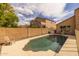Backyard pool area surrounded by mature landscaping, a privacy fence, and a sunny patio, perfect for relaxation at 1648 S Faith --, Mesa, AZ 85209