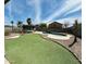 Backyard featuring a swimming pool, artificial turf, and ample space for entertaining at 1677 E Heather Dr, San Tan Valley, AZ 85140