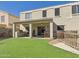 Charming backyard featuring a covered patio, outdoor kitchen, and lush green lawn at 1677 E Heather Dr, San Tan Valley, AZ 85140