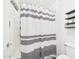 Bathroom with a shower/tub combination and decorative wall shelves at 1677 E Heather Dr, San Tan Valley, AZ 85140