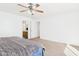 Bright bedroom features a ceiling fan and an ensuite bathroom entrance at 1677 E Heather Dr, San Tan Valley, AZ 85140