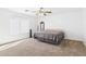 Neutral bedroom with tan carpet, ceiling fan, and a sun-drenched window at 1677 E Heather Dr, San Tan Valley, AZ 85140