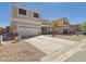 Two-story home featuring a two-car garage and concrete driveway at 1677 E Heather Dr, San Tan Valley, AZ 85140