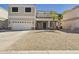 Charming two-story home featuring a two-car garage and drought-tolerant landscaping at 1677 E Heather Dr, San Tan Valley, AZ 85140