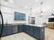 Kitchen featuring stainless steel appliances, stylish blue cabinets and tile flooring at 1677 E Heather Dr, San Tan Valley, AZ 85140