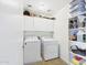 Laundry room with washer, dryer, storage cabinets, and shelving at 1677 E Heather Dr, San Tan Valley, AZ 85140