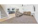 Bright living room with neutral carpet, leather seating, stairs, and open to the kitchen at 1677 E Heather Dr, San Tan Valley, AZ 85140