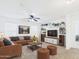 Cozy living room featuring a plush couch, entertainment center, and recessed lighting at 1677 E Heather Dr, San Tan Valley, AZ 85140