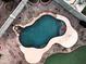 Aerial view of backyard pool with unique design and surrounding patio space at 1677 E Heather Dr, San Tan Valley, AZ 85140