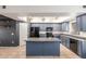 Well-equipped kitchen featuring blue cabinets, recessed lighting and tile flooring at 16825 N 14Th St # 125, Phoenix, AZ 85022