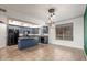 Eat-in kitchen with blue cabinets, sleek black appliances and tile flooring at 16825 N 14Th St # 125, Phoenix, AZ 85022