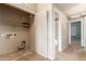 Hallway with laundry room featuring washer dryer hookups and storage shelves at 16825 N 14Th St # 125, Phoenix, AZ 85022