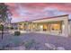 Expansive covered patio with ample seating, overlooking a meticulously landscaped yard, perfect for outdoor gatherings and relaxation at 16927 W Desert Blossom Way, Surprise, AZ 85387
