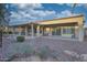 A spacious back patio with an overhang, seating areas, and desert landscaping is perfect for relaxing and entertaining at 16927 W Desert Blossom Way, Surprise, AZ 85387