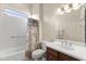 Bathroom features a shower-tub combo with a privacy curtain and a vanity sink with good lighting at 16927 W Desert Blossom Way, Surprise, AZ 85387