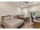 Comfortable bedroom with a desk and a sewing machine and plenty of natural light through arched windows at 16927 W Desert Blossom Way, Surprise, AZ 85387