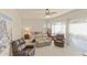 Bright bedroom with neutral carpet, ceiling fan and multiple seating areas at 16927 W Desert Blossom Way, Surprise, AZ 85387