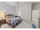 This bedroom has carpet, two closets, an ensuite bath, and a ceiling fan for maximum comfort at 16927 W Desert Blossom Way, Surprise, AZ 85387