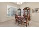 Elegant dining room with shuttered windows, complemented by a classic wood table set and a decorative china cabinet at 16927 W Desert Blossom Way, Surprise, AZ 85387