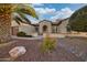 Charming home with desert landscaping, arched entryway and a welcoming facade at 16927 W Desert Blossom Way, Surprise, AZ 85387