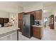 Open kitchen layout blending into living area, featuring stainless steel appliances and granite counters at 16927 W Desert Blossom Way, Surprise, AZ 85387