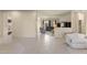 Inviting living space featuring tile flooring, neutral tones, and views into a bright living room with a fireplace at 16927 W Desert Blossom Way, Surprise, AZ 85387