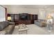 Well-lit living room with leather seating, custom built-ins, and a cozy ambiance, perfect for relaxation and entertainment at 16927 W Desert Blossom Way, Surprise, AZ 85387