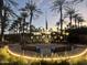 Veterans memorial with American flag, lit benches, and palm trees at sunset at 16927 W Desert Blossom Way, Surprise, AZ 85387
