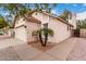 Tan house featuring a garage, walkway, palm trees, and lush landscaping at 1811 S 39Th St # 29, Mesa, AZ 85206