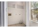 Laundry room featuring utility connections, shelving, tile flooring, and natural light from a window at 1811 S 39Th St # 29, Mesa, AZ 85206