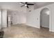 Open-concept living room with tile flooring, neutral paint, and arched doorways at 1811 S 39Th St # 29, Mesa, AZ 85206