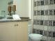 Bathroom with single sink vanity, toilet, and patterned shower curtain at 18416 N Cave Creek Rd # 1053, Phoenix, AZ 85032