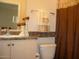 Traditional bathroom with a vanity sink, decorative candle sticks, and neutral brown and beige tones at 18416 N Cave Creek Rd # 1053, Phoenix, AZ 85032