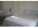 Bright bedroom featuring a mirrored closet and a comfortable bed with patterned bedding and neutral colored walls at 18416 N Cave Creek Rd # 1053, Phoenix, AZ 85032