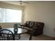 Cozy living room with dark brown sofa, side tables, and natural lighting at 18416 N Cave Creek Rd # 1053, Phoenix, AZ 85032
