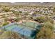 Aerial view showcases neighborhood sport courts, lush landscaping, and mountain views at 18552 N 94Th St, Scottsdale, AZ 85255