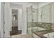 Modern bathroom with glass-enclosed shower and a view into a spacious walk-in closet at 18552 N 94Th St, Scottsdale, AZ 85255