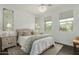 Cozy bedroom with neutral decor, a crystal chandelier, and view to the exterior at 18552 N 94Th St, Scottsdale, AZ 85255