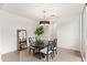 Bright dining room featuring a chandelier, a plant on the table and a full length mirror at 18552 N 94Th St, Scottsdale, AZ 85255