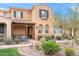 Charming two-story home showcasing a tile roof, desert landscaping and stucco exterior at 18552 N 94Th St, Scottsdale, AZ 85255