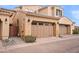 Attached two-car garage with automatic door, decorative lamps, and desert landscaping at 18552 N 94Th St, Scottsdale, AZ 85255