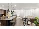 Open concept kitchen island featuring modern pendant lights, counter seating, and sight lines to the living space at 18552 N 94Th St, Scottsdale, AZ 85255