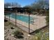 Community swimming pool with sun loungers and a covered patio area, all enclosed by a secure wrought iron fence at 18552 N 94Th St, Scottsdale, AZ 85255