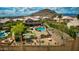 Expansive backyard featuring a pool, putting green, and seating area with a mountain view at 1922 E Saltsage Dr, Phoenix, AZ 85048