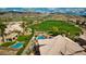 Gorgeous aerial view of a luxury home featuring a sparkling pool and lush golf course views at 1922 E Saltsage Dr, Phoenix, AZ 85048