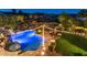 Backyard with custom pool, spa, grass, mature landscape and seating for entertaining with mountain views at 1922 E Saltsage Dr, Phoenix, AZ 85048
